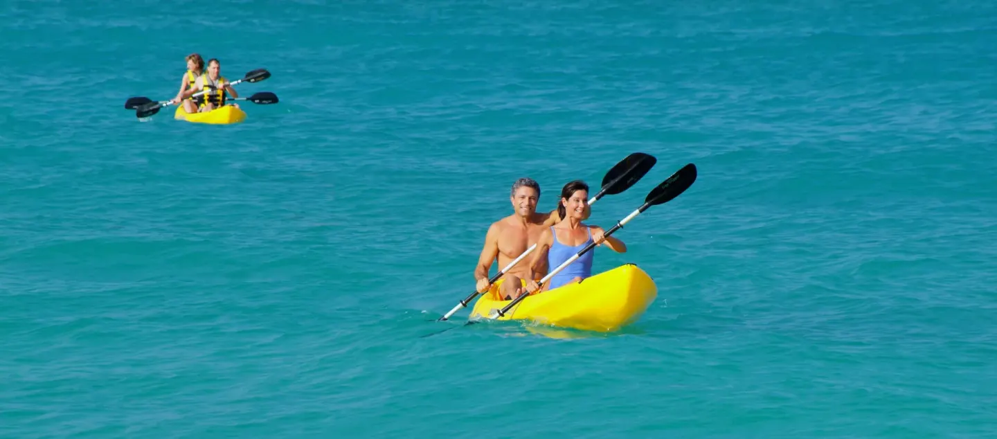 Guests kayaking on turquoise water near Iberostar Selection Bávaro Suites.