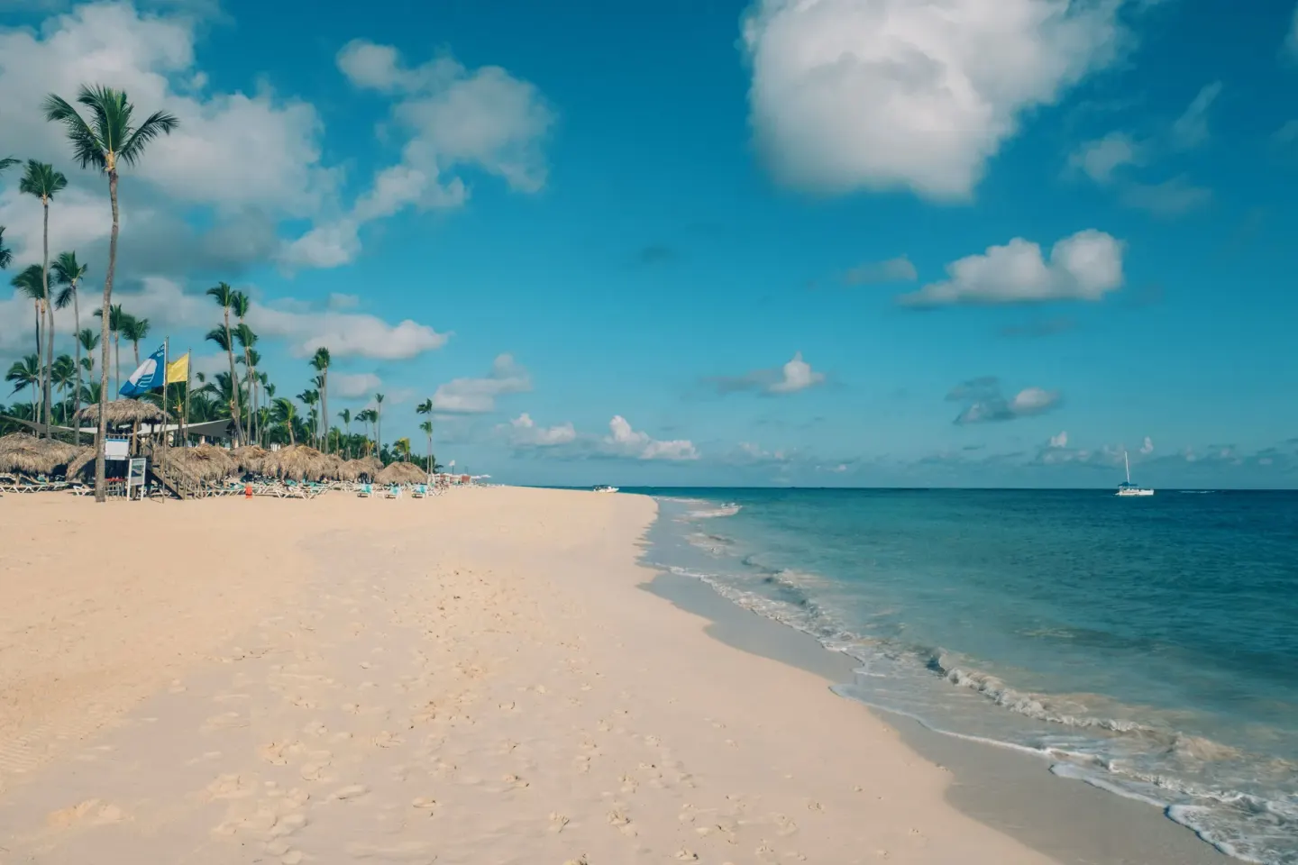 Long sandy shoreline with palapas and calm water at Iberostar Selection Bávaro Suites.