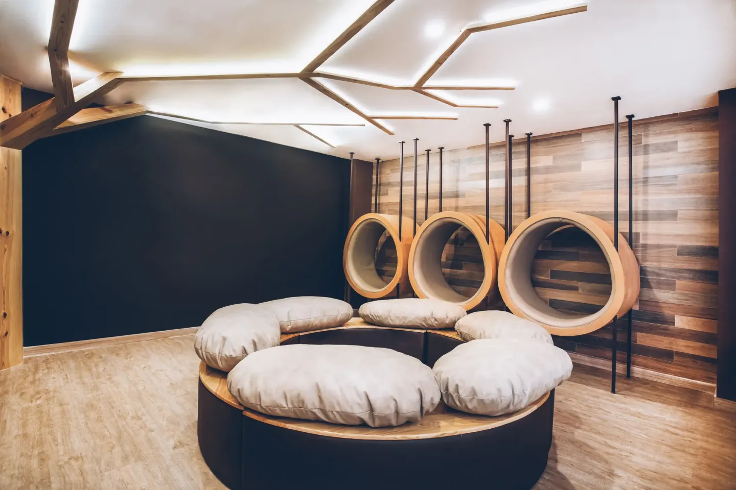 Lounge area with circular hanging seats at Iberostar Selection Bávaro Suites.
