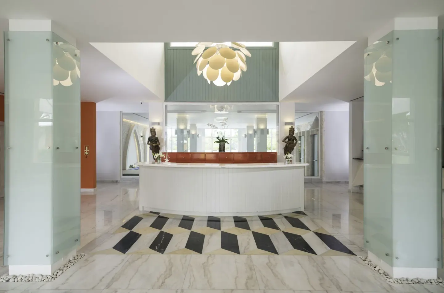 White spa reception desk and glass panels at Iberostar Selection Bávaro Suites.