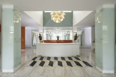White spa reception desk and glass panels at Iberostar Selection Bávaro Suites.