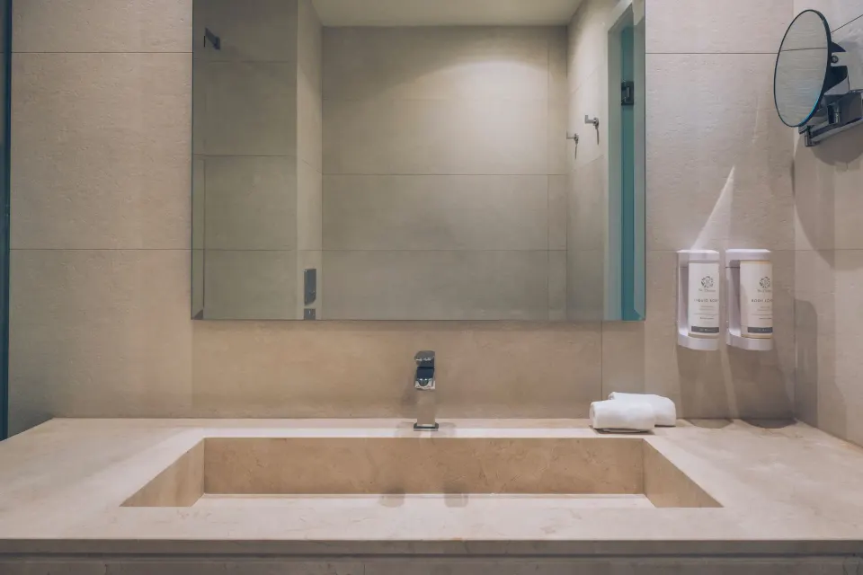 Junior Suite bathroom vanity with mirror and amenities at Iberostar Selection Bávaro Suites.
