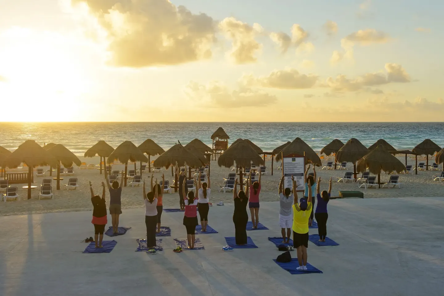 Sunrise beach exercise class facing the ocean at Iberostar Selection Cancún.