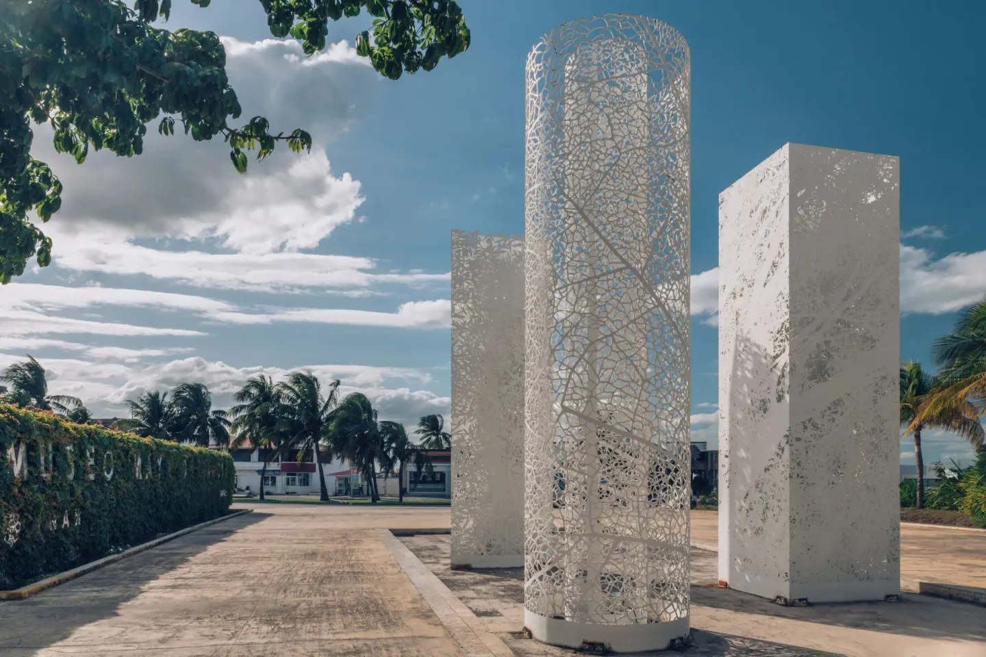 White sculptural entrance columns under a blue sky at Iberostar Selection Cancún.