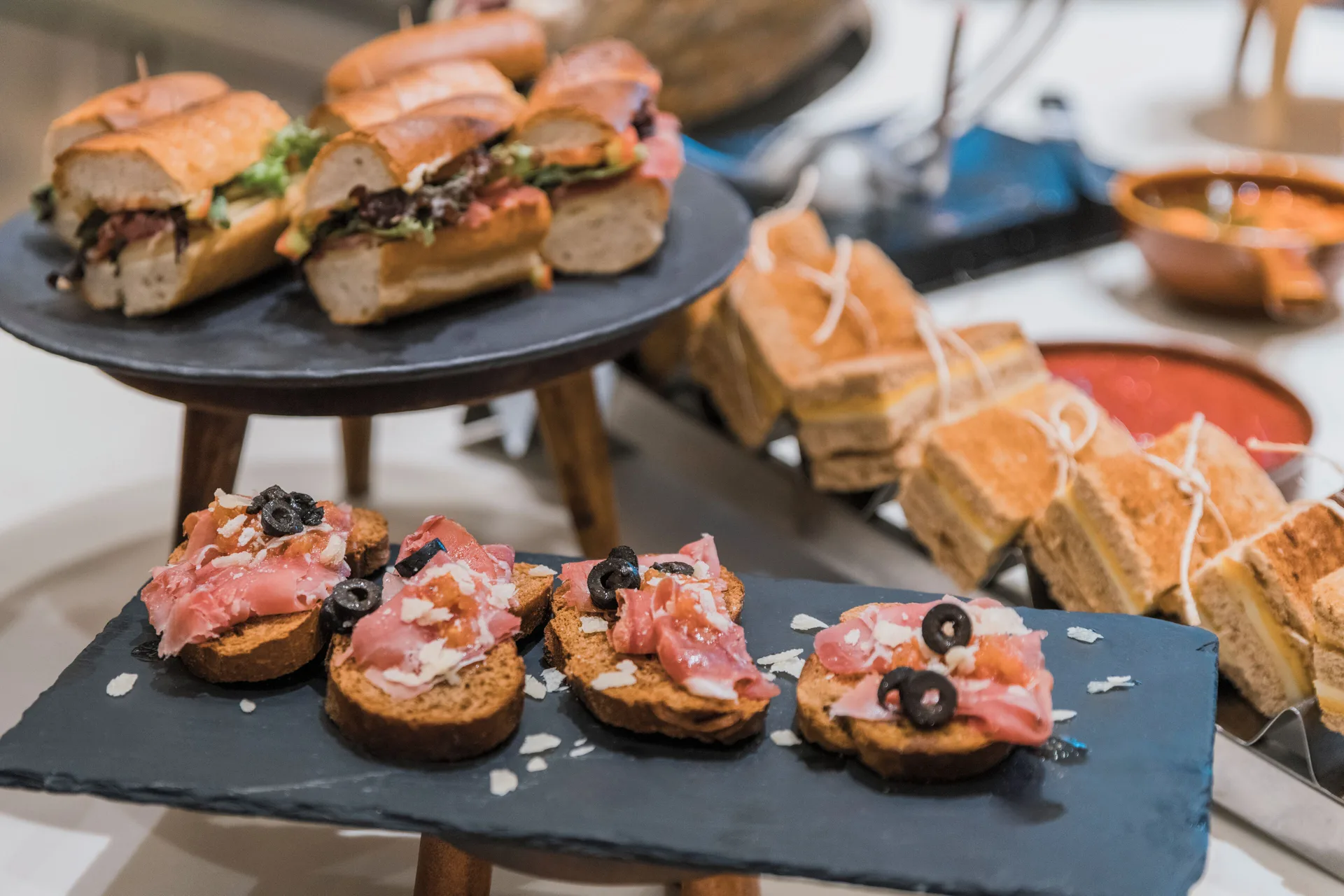 Assorted small sandwiches and toast bites displayed at Iberostar Selection Cancún.