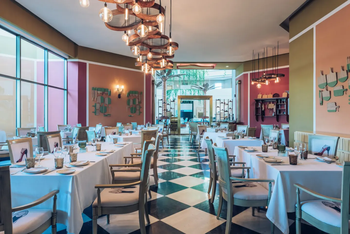 Colorful restaurant dining room with set tables at Iberostar Selection Cancún.