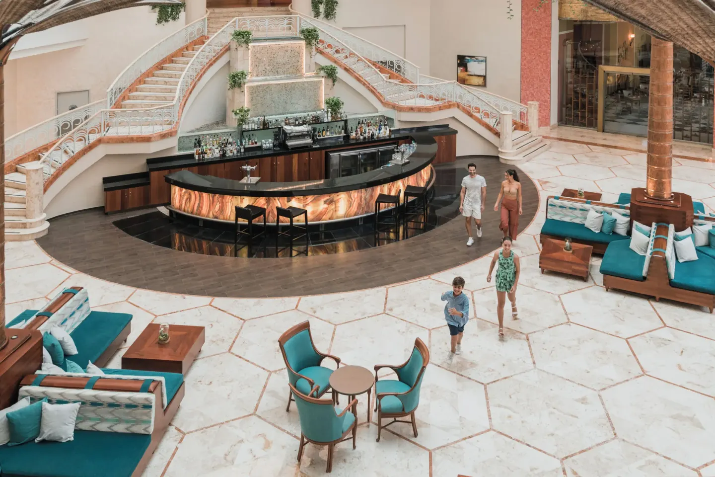 Lobby bar with curved counter and lounge seating at Iberostar Selection Cancún.