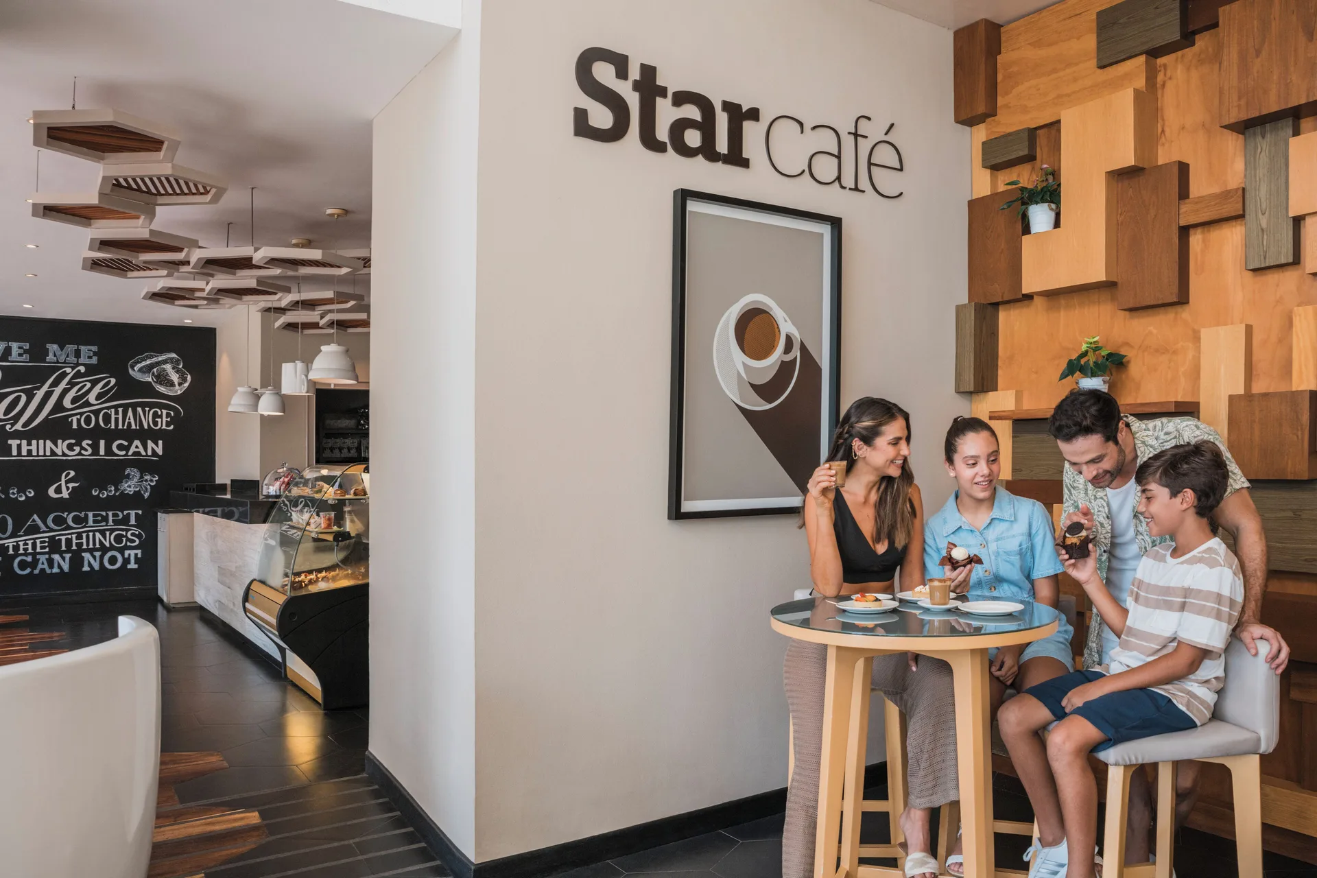 Family seated by the Star Café sign at Iberostar Selection Cancún.