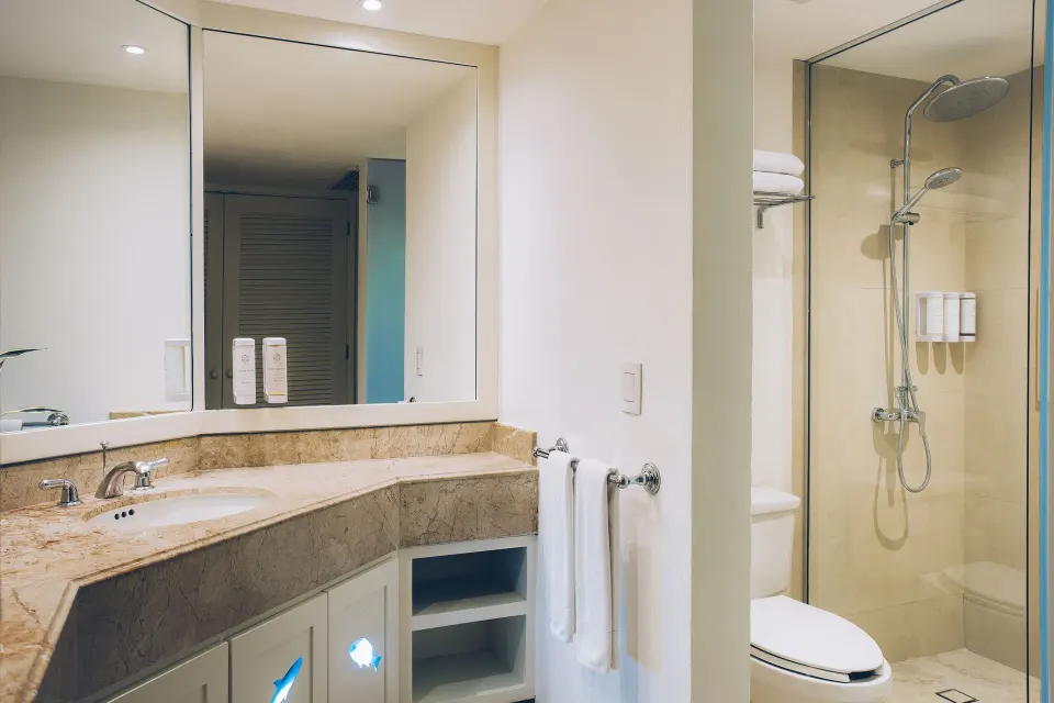 Premium Room bathroom with vanity and glass shower at Iberostar Selection Cancún.