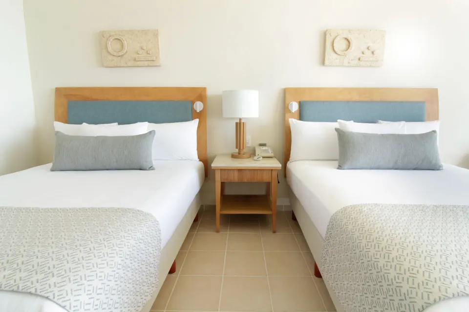 Two-bed Premium Room with shared nightstand at Iberostar Selection Cancún.