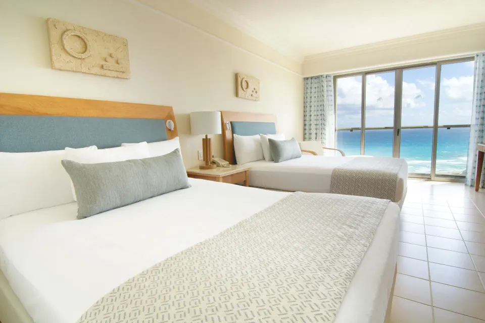 Premium Room ocean view with two beds and sliding glass doors at Iberostar Selection Cancún.