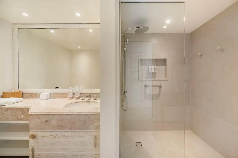 Suite Ocean View bathroom with vanity and glass shower at Iberostar Selection Cancún.