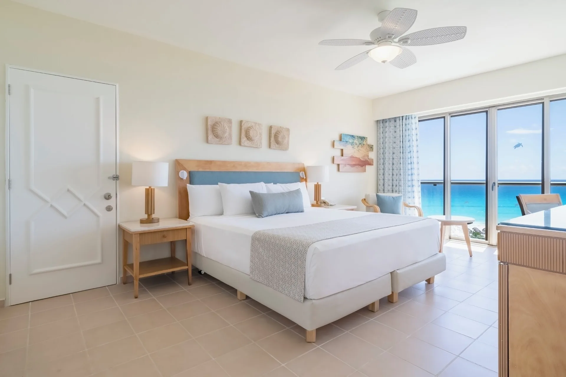 Suite Ocean View bedroom with king bed and balcony at Iberostar Selection Cancún.