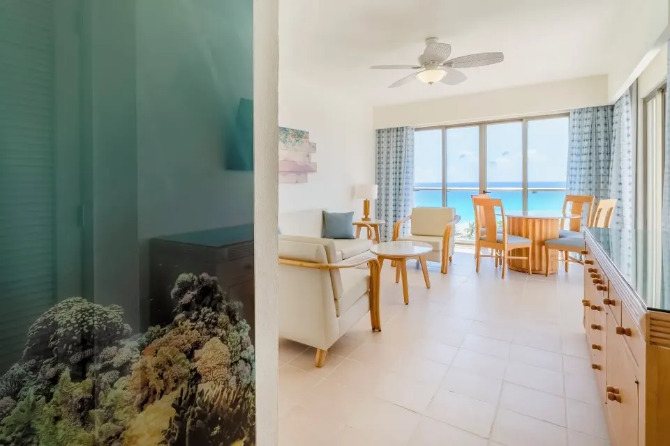 Suite Ocean View sitting area with dining table and sea view at Iberostar Selection Cancún.