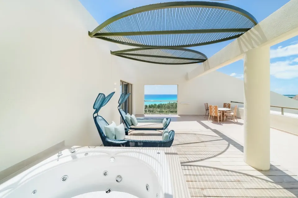 Suite Ocean View terrace with whirlpool tub and lounge seating at Iberostar Selection Cancún.