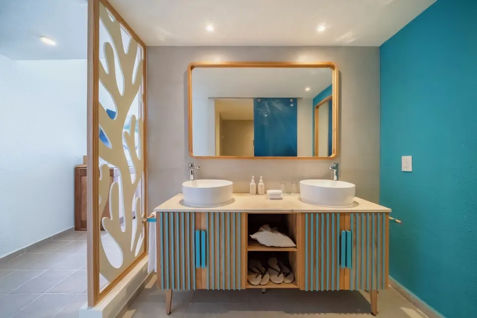 Oceanfront suite bathroom with double vessel sinks at Iberostar Selection Cancún.