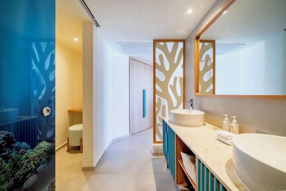 Oceanfront suite bathroom vanity and hallway at Iberostar Selection Cancún.