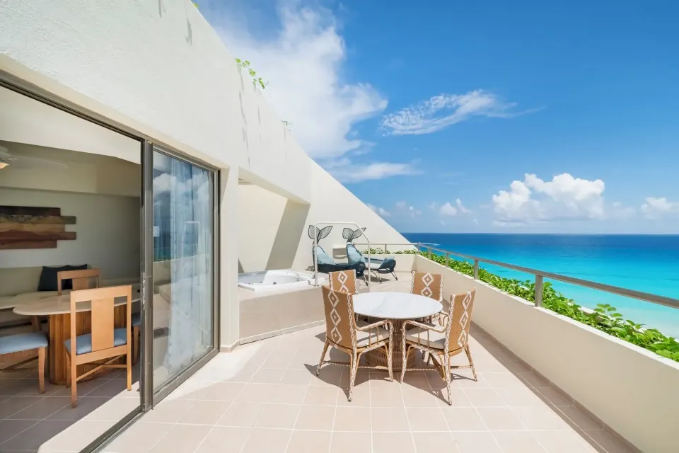 Oceanfront suite terrace with dining table and sea view at Iberostar Selection Cancún.