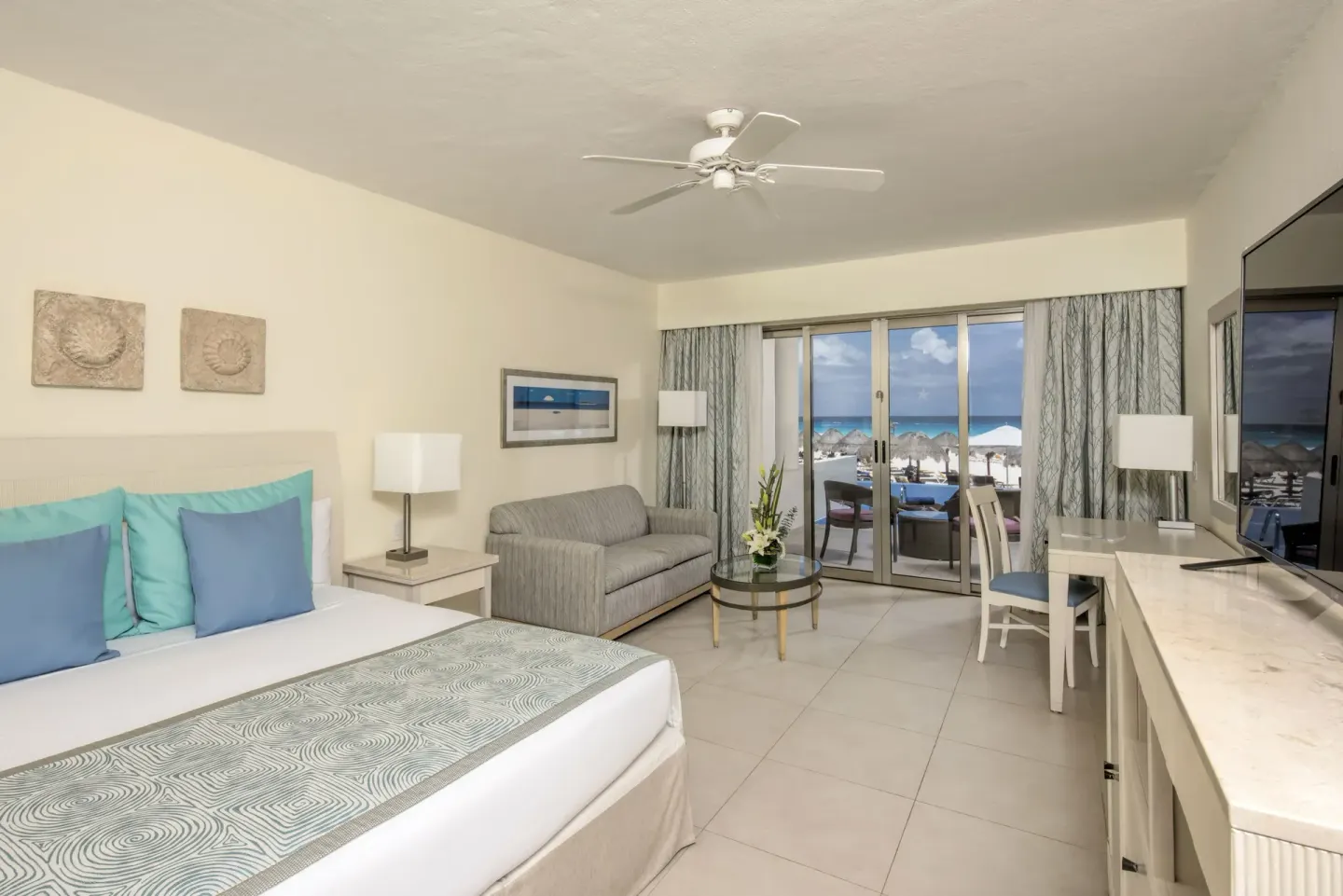Oceanfront swim-out villa room with king bed and patio view at Iberostar Selection Cancún.