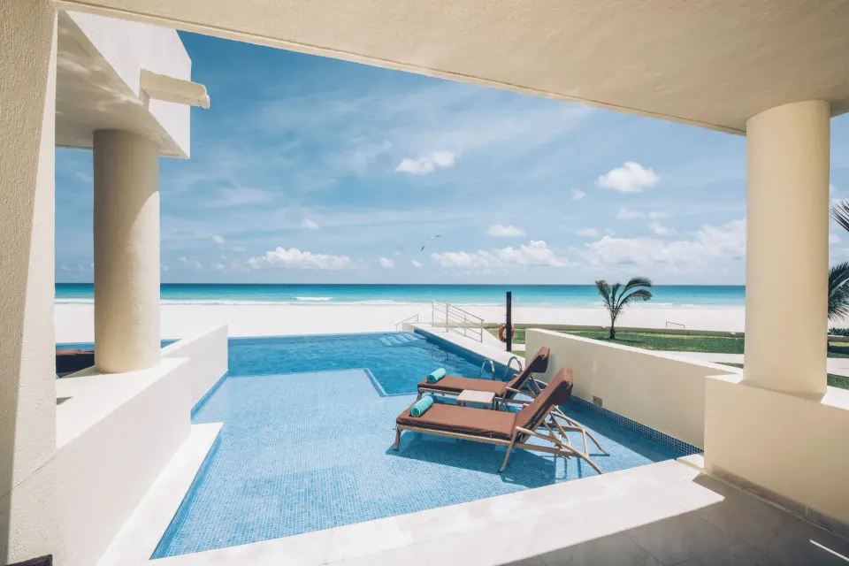 Oceanfront swim-out villa terrace with pool and loungers at Iberostar Selection Cancún.