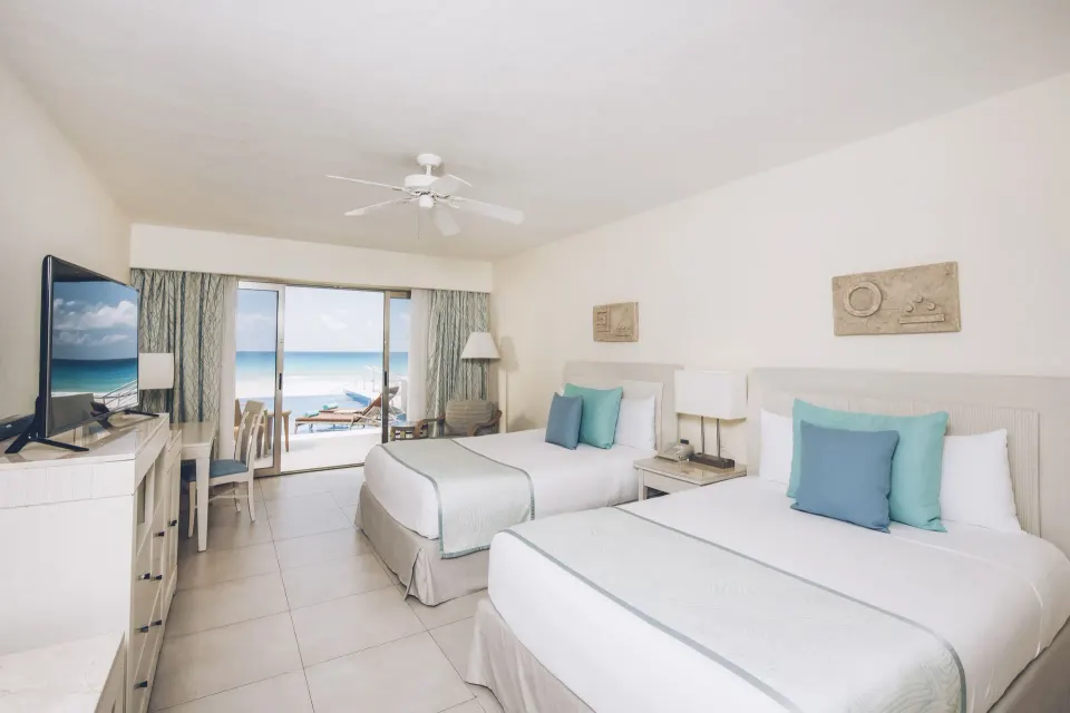 Oceanfront swim-out villa room with two double beds at Iberostar Selection Cancún.