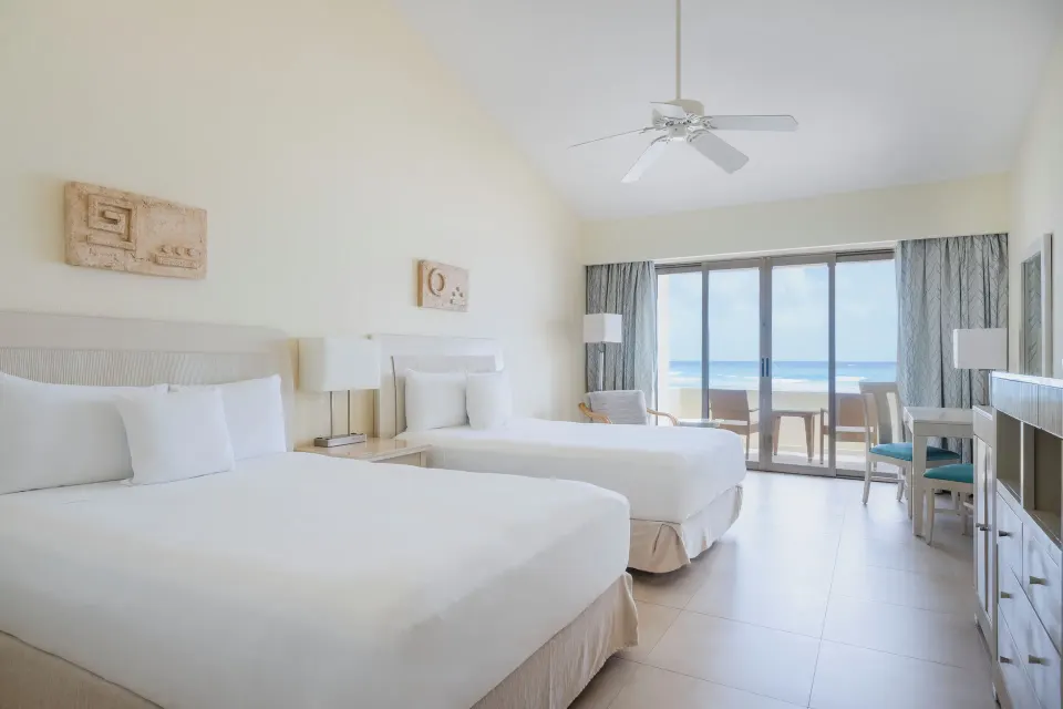 Oceanfront villa room with two beds and balcony view at Iberostar Selection Cancún.