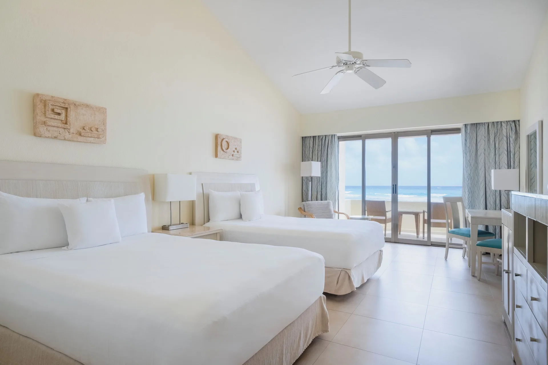 Oceanfront villa room with two beds and balcony view at Iberostar Selection Cancún.