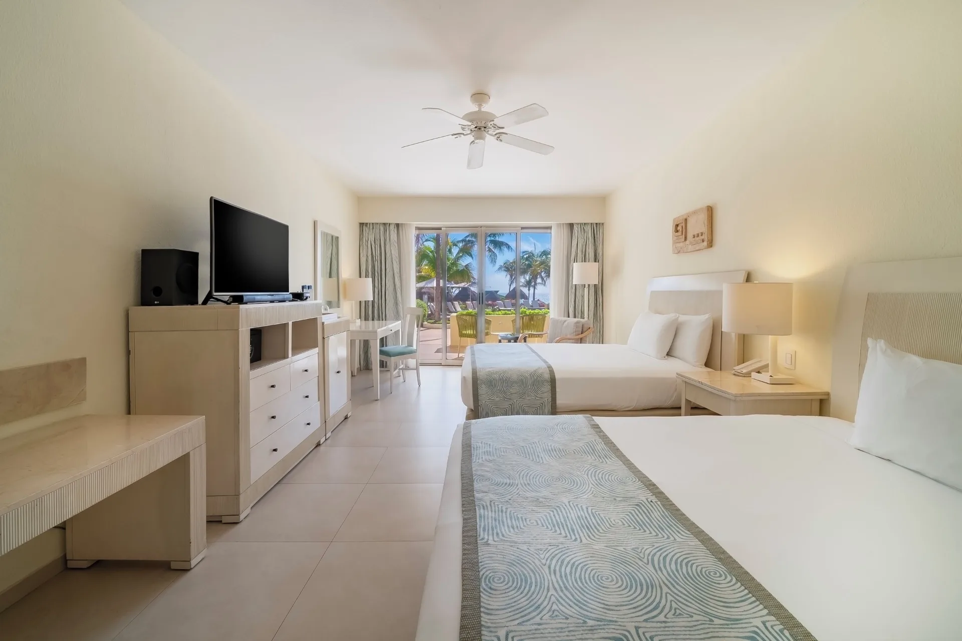 Villa Poolside room with two beds and patio view at Iberostar Selection Cancún.