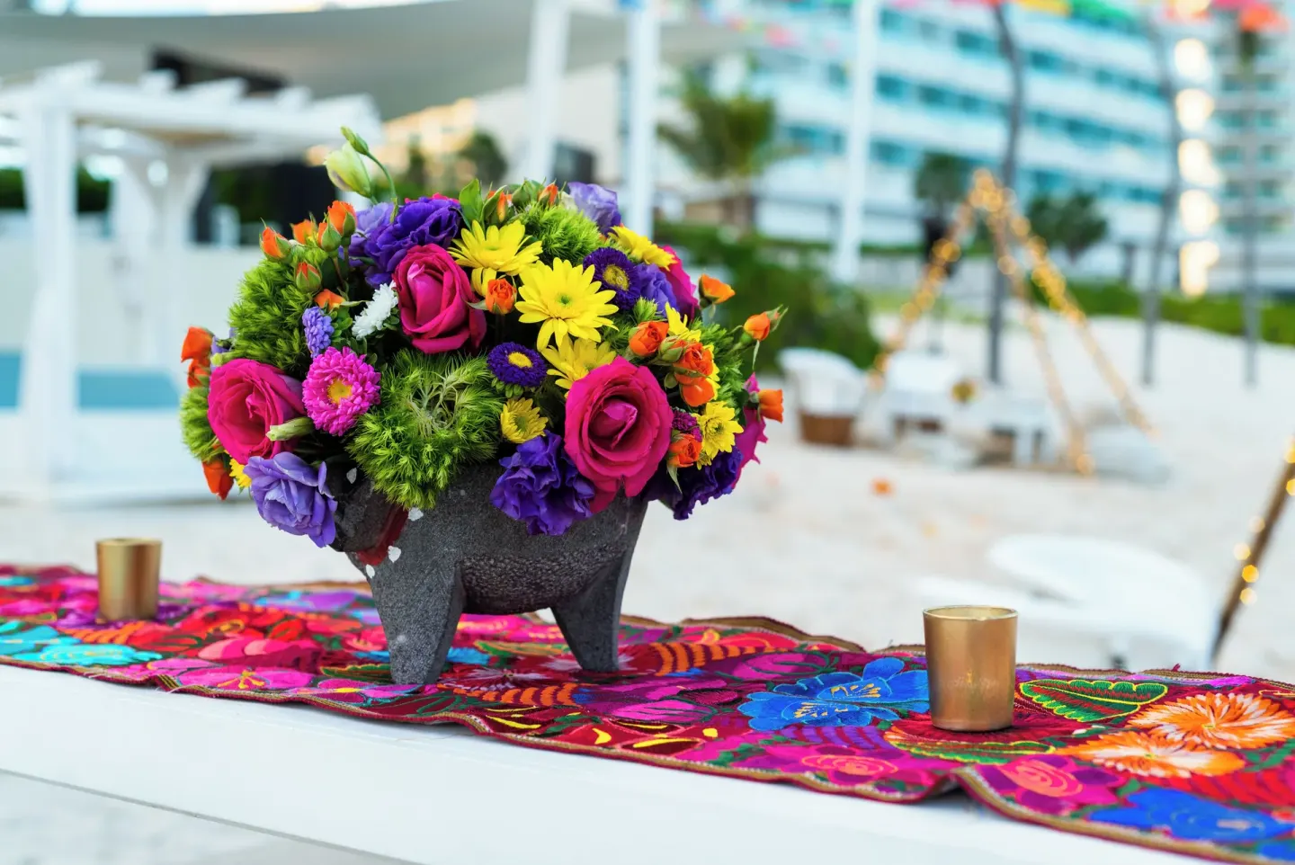 Colorful floral centerpiece on a patterned table runner at Iberostar Selection Cancún.