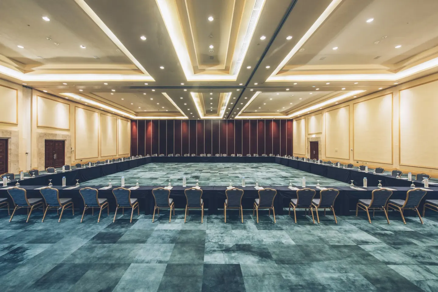 Large conference room with U-shaped tables at Iberostar Selection Cancún.