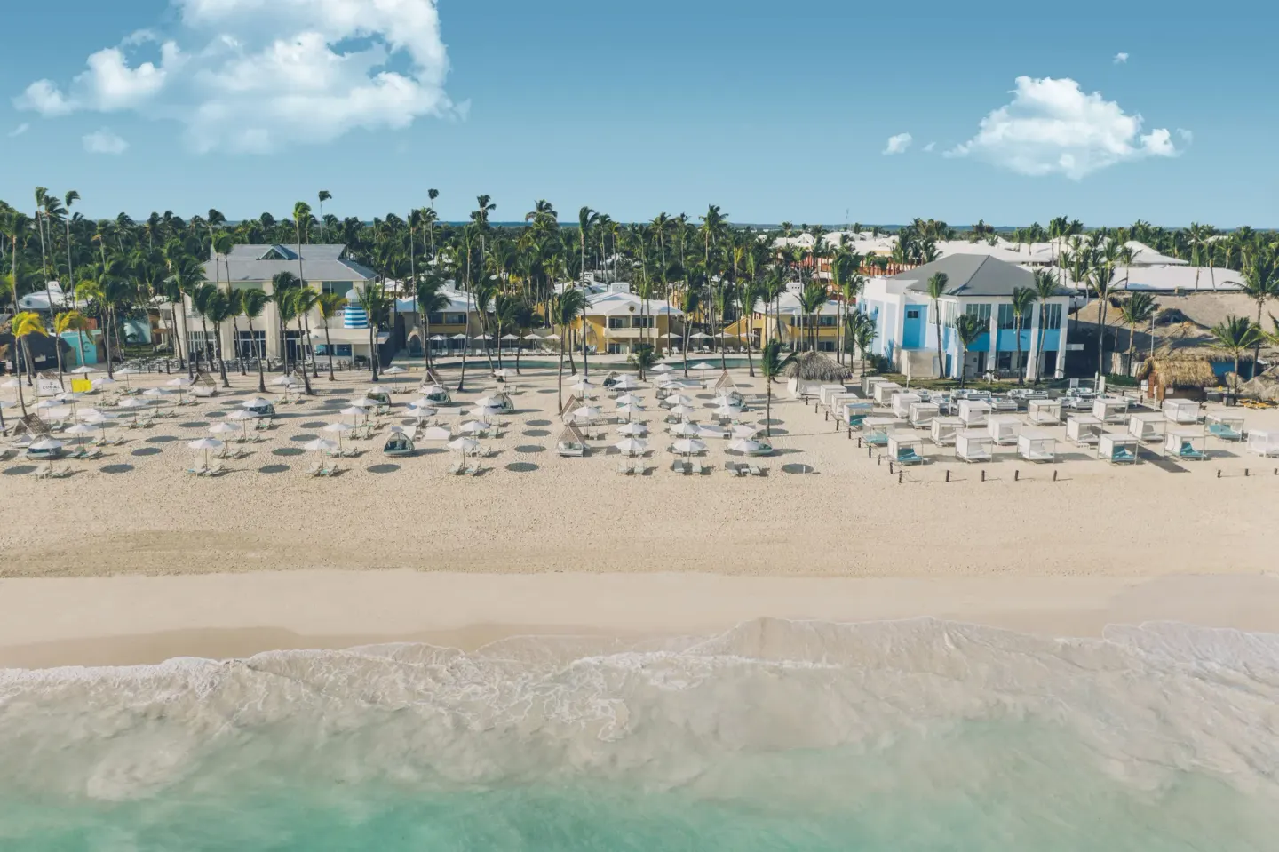 Aerial view of the beach, loungers, palms, and resort buildings at Iberostar Selection Coral Bávaro.