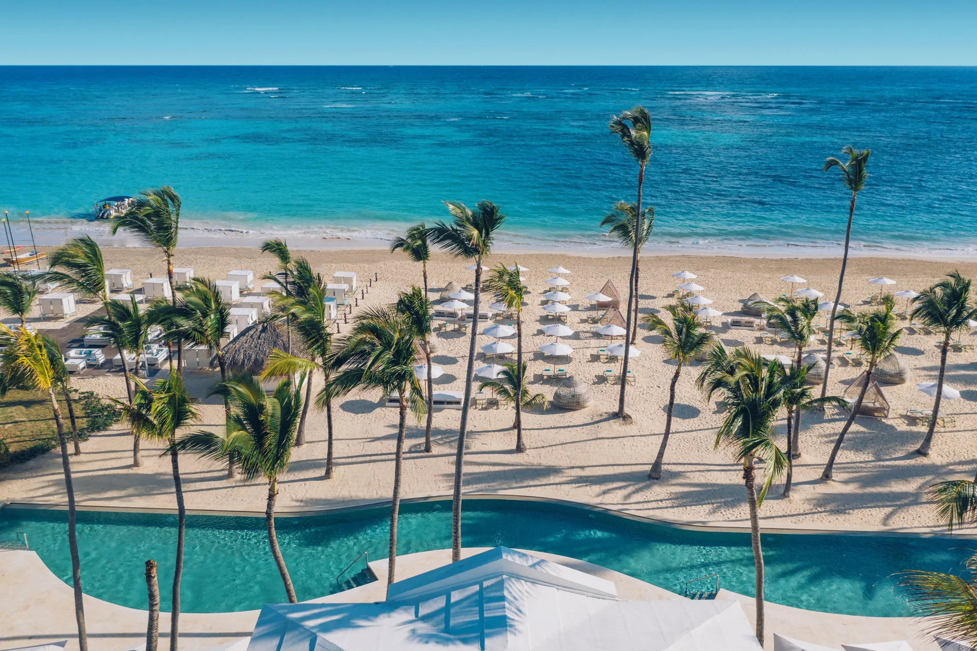 Beach, palms, loungers, and turquoise sea at Iberostar Selection Coral Bávaro.