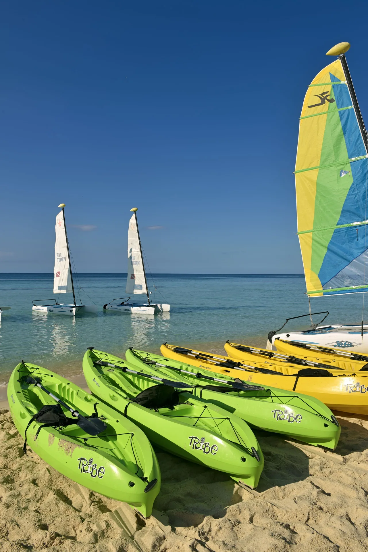 Kayaks and small sailboats on the beach at Iberostar Selection Coral Bávaro.