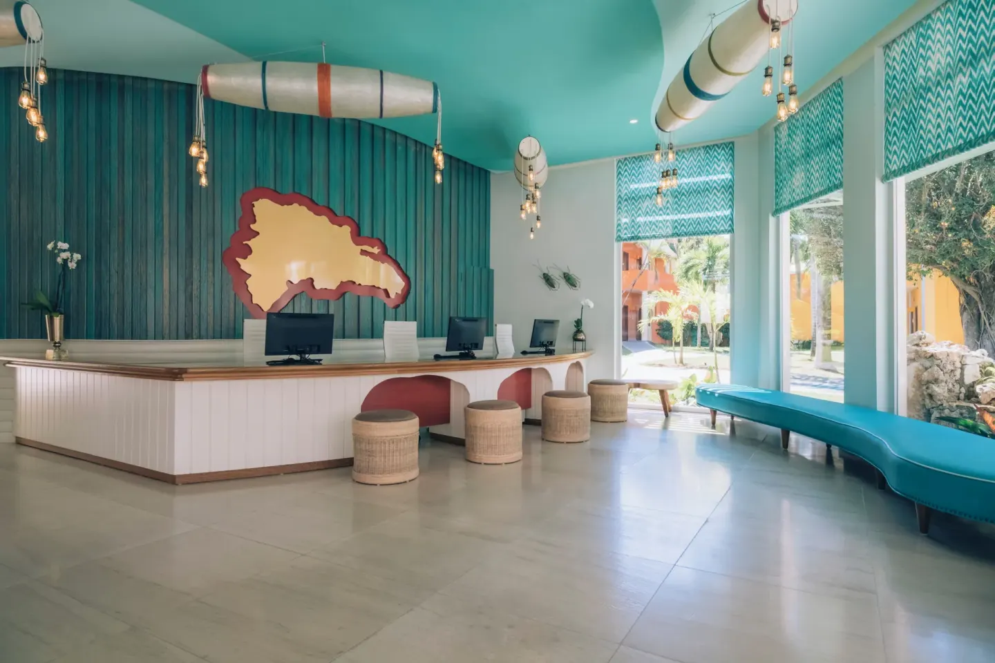 Lobby reception desk with turquoise decor at Iberostar Selection Coral Bávaro.
