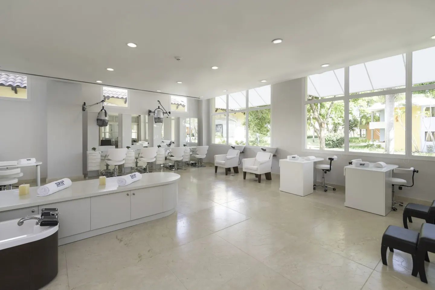 Bright salon area with styling chairs and pedicure stations at Iberostar Selection Coral Bávaro.
