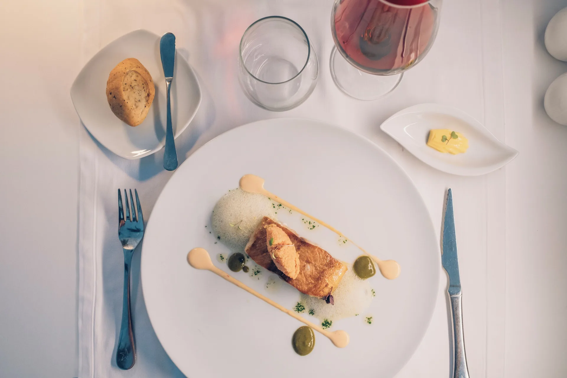 Plated entrée with wine and bread at Iberostar Selection Coral Bávaro.