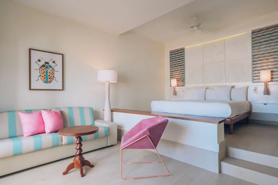 Junior Suite Oceanfront king bed and sofa area at Iberostar Selection Coral Bávaro.