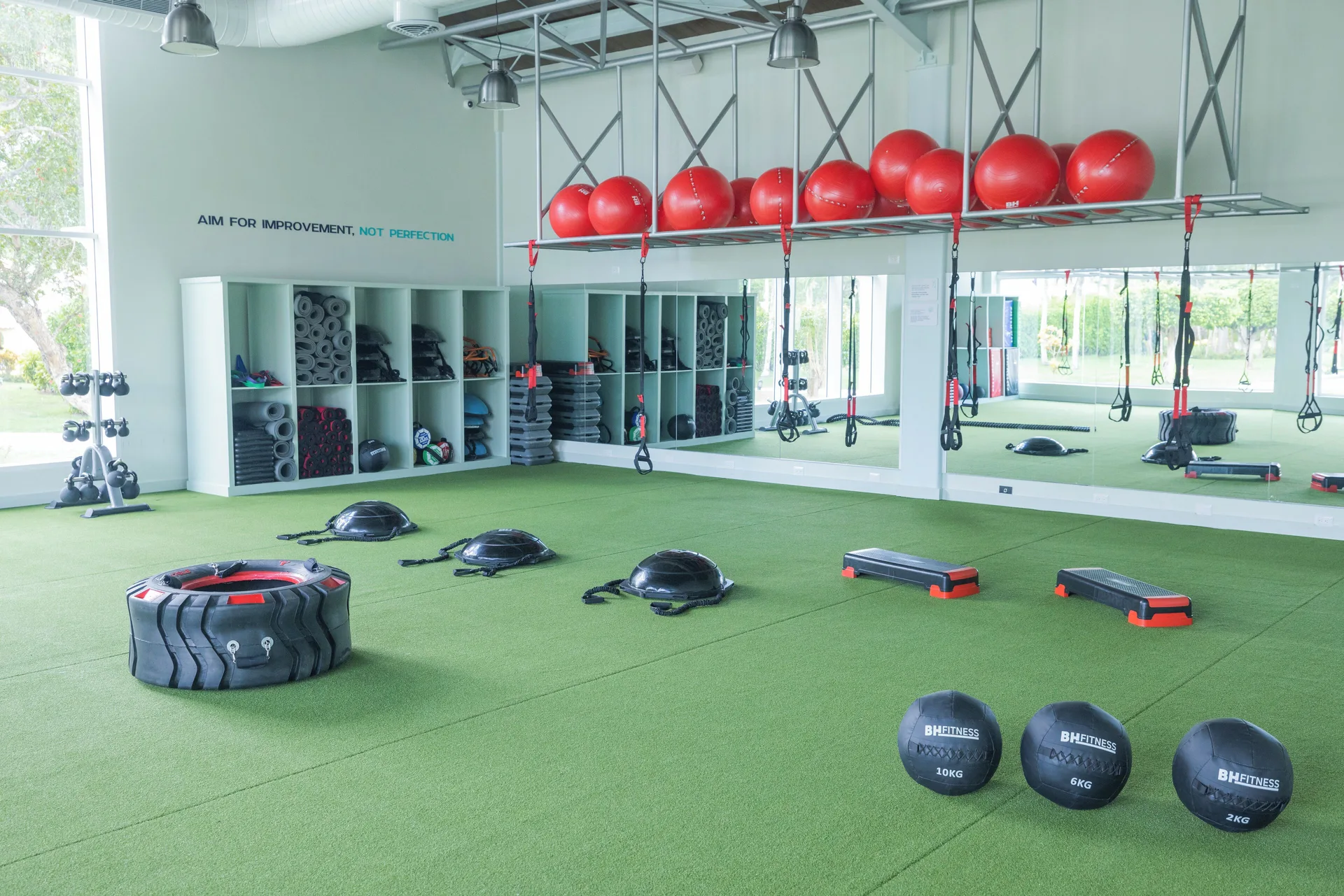 Fitness studio with turf, suspension straps, and exercise gear at Iberostar Selection Hacienda Dominicus.
