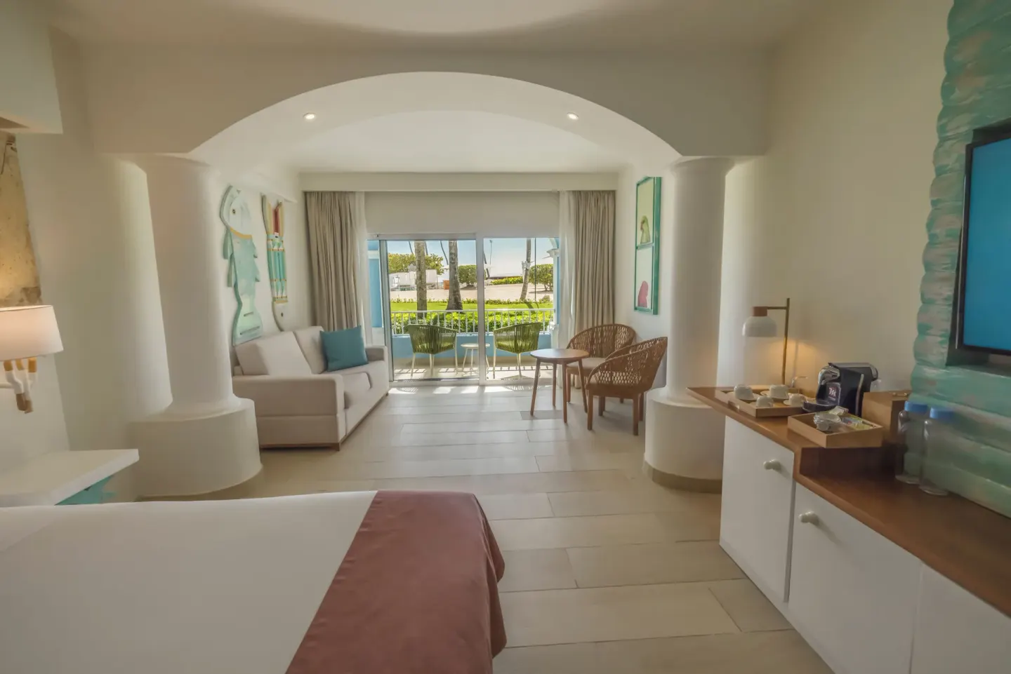Guest room with king bed, sitting area and balcony at Iberostar Selection Hacienda Dominicus.