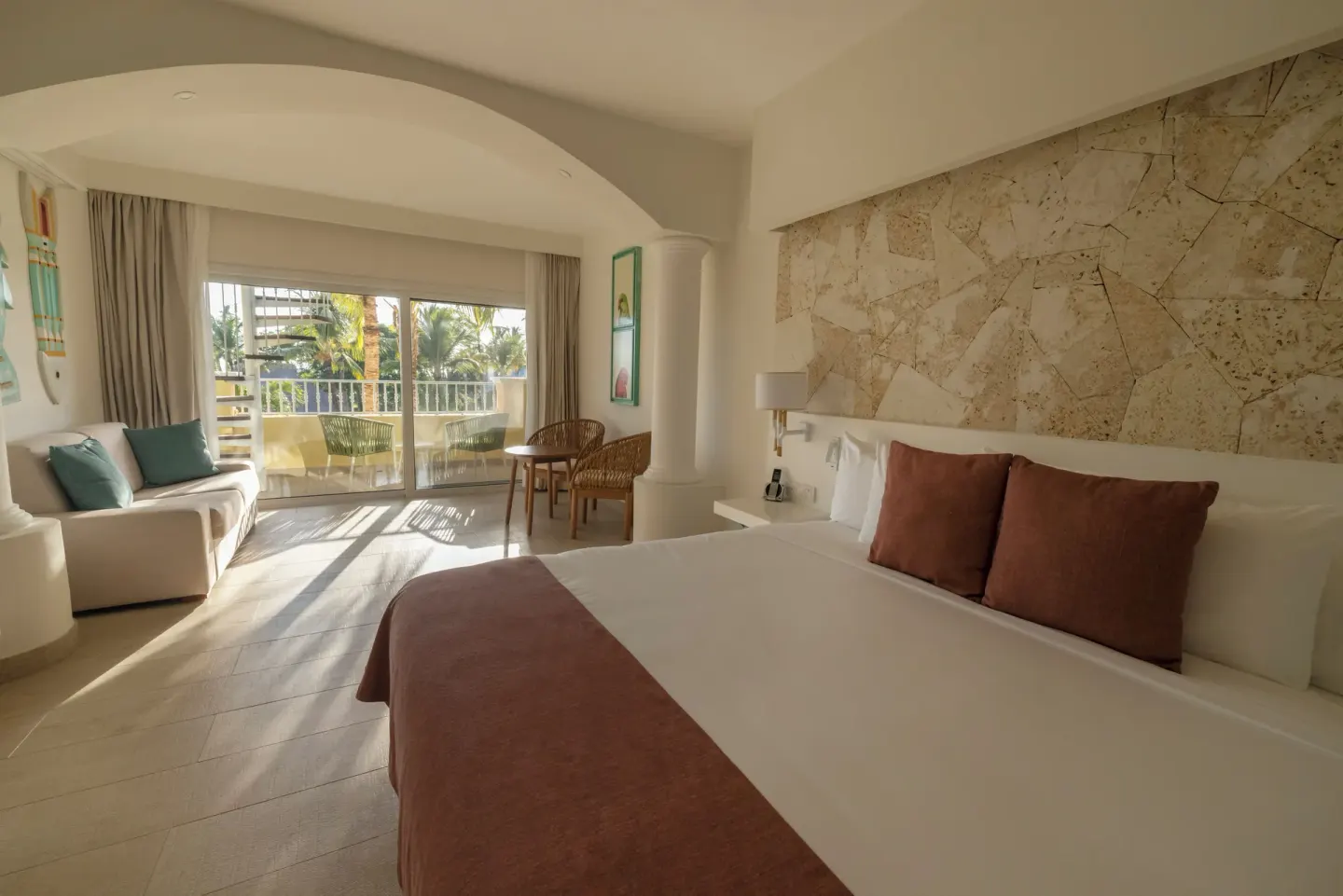 King bed guest room with balcony seating at Iberostar Selection Hacienda Dominicus.