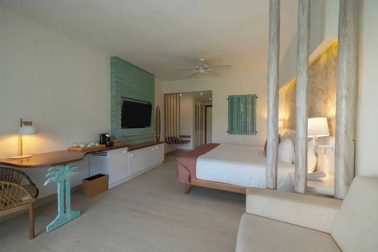 Guest room with king bed, desk and TV console at Iberostar Selection Hacienda Dominicus.