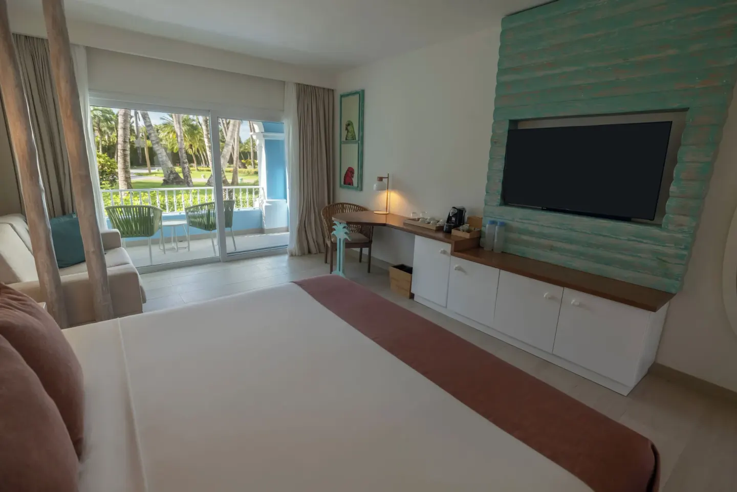 Guest room with king bed, TV console and balcony view at Iberostar Selection Hacienda Dominicus.