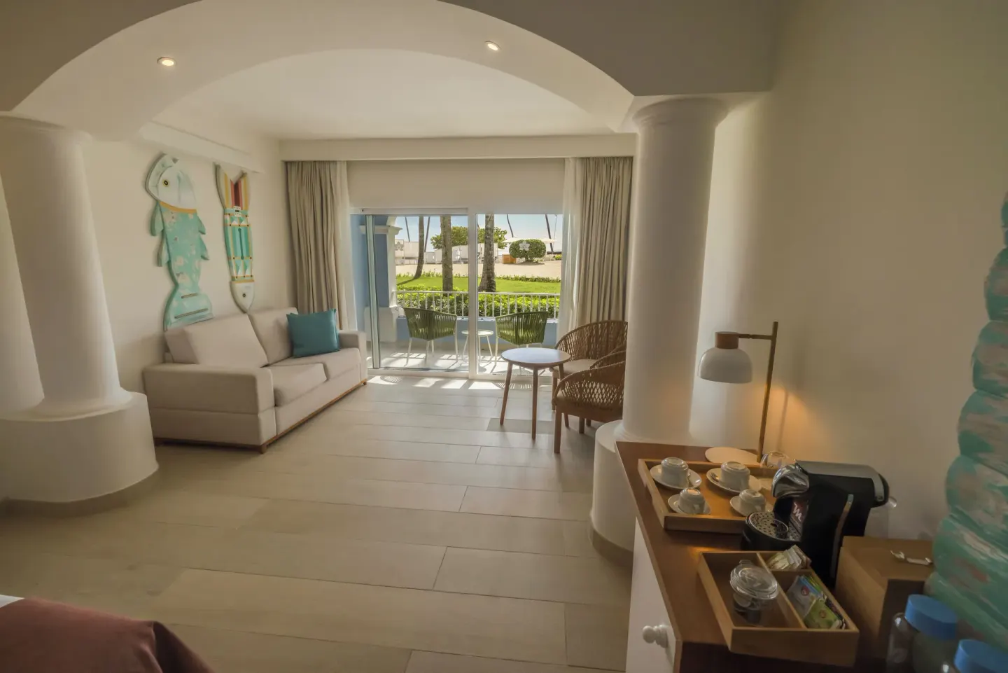 Guest room lounge area with coffee setup and balcony at Iberostar Selection Hacienda Dominicus.