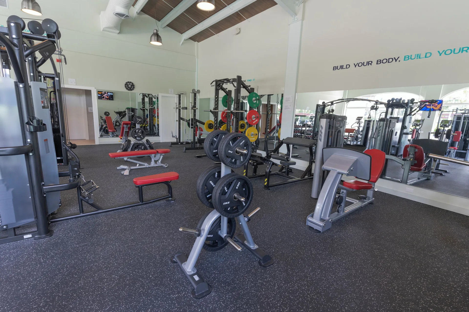 Gym with weight machines and benches at Iberostar Selection Hacienda Dominicus.