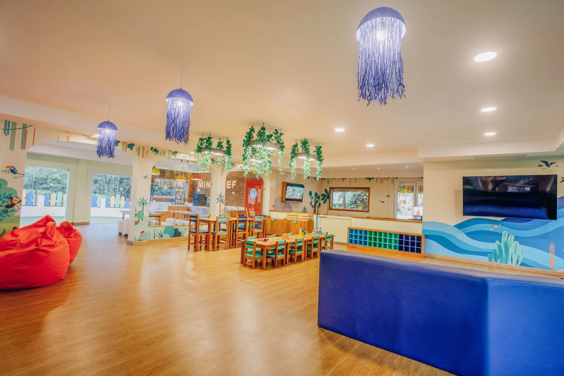 Spacious kids' club with small tables and lounge seating at Iberostar Selection Hacienda Dominicus.
