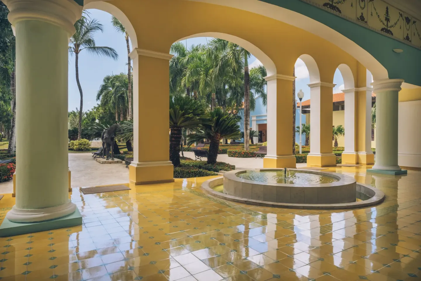 Open-air arched walkway and fountain at Iberostar Selection Hacienda Dominicus.