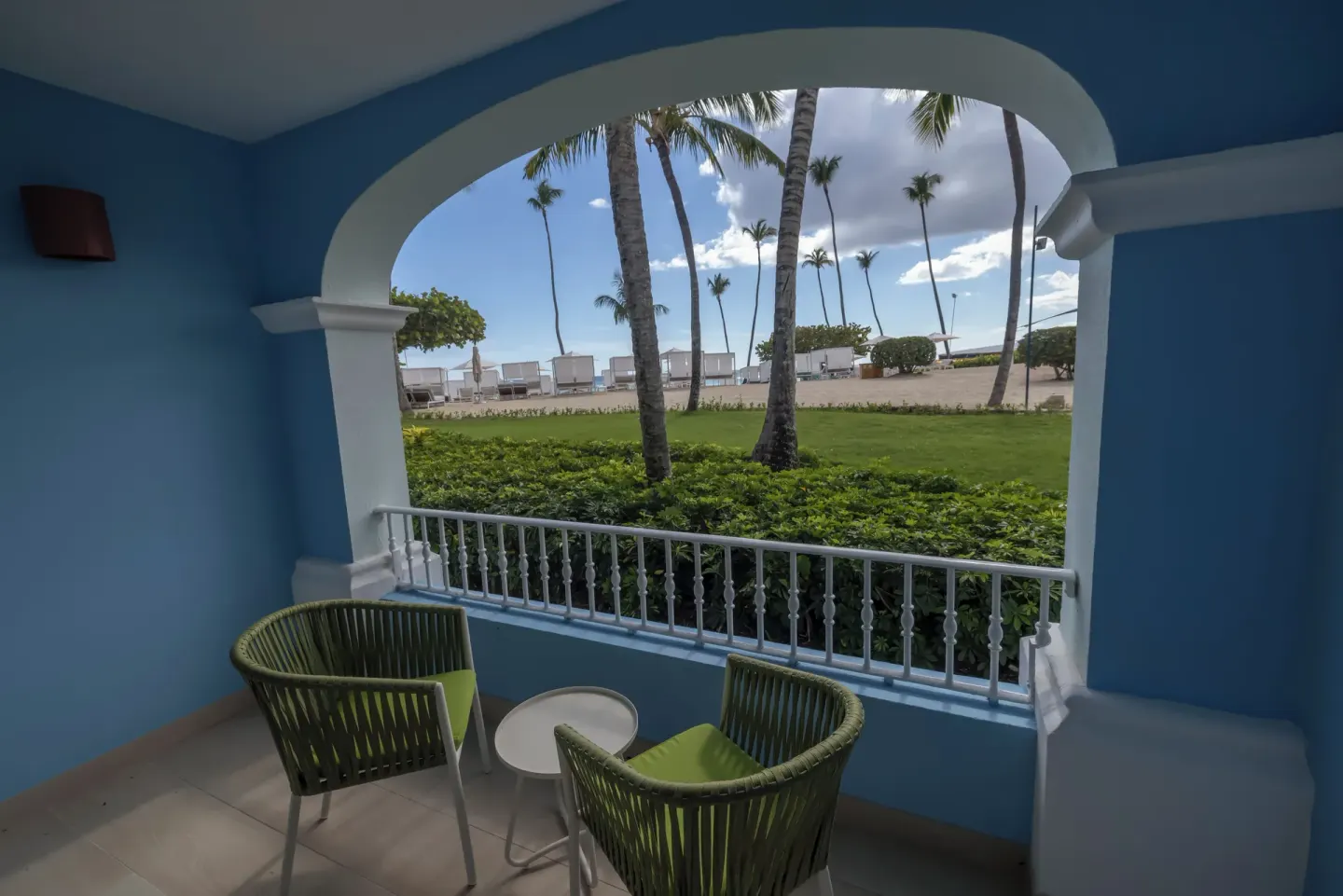 Shaded blue balcony with garden and palms at Iberostar Selection Hacienda Dominicus.
