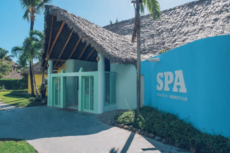 Spa entrance with turquoise wall at Iberostar Selection Hacienda Dominicus.