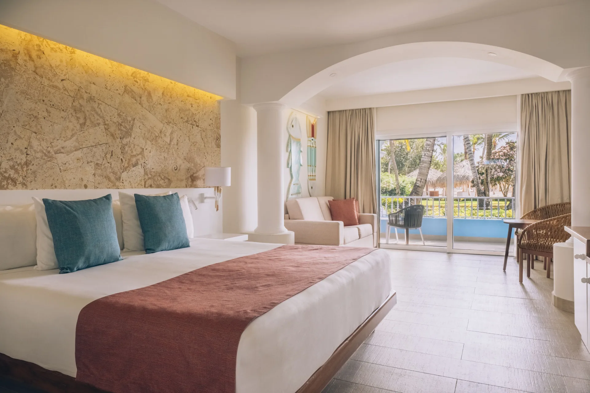 King bed suite with balcony doors and palm views at Iberostar Selection Hacienda Dominicus.