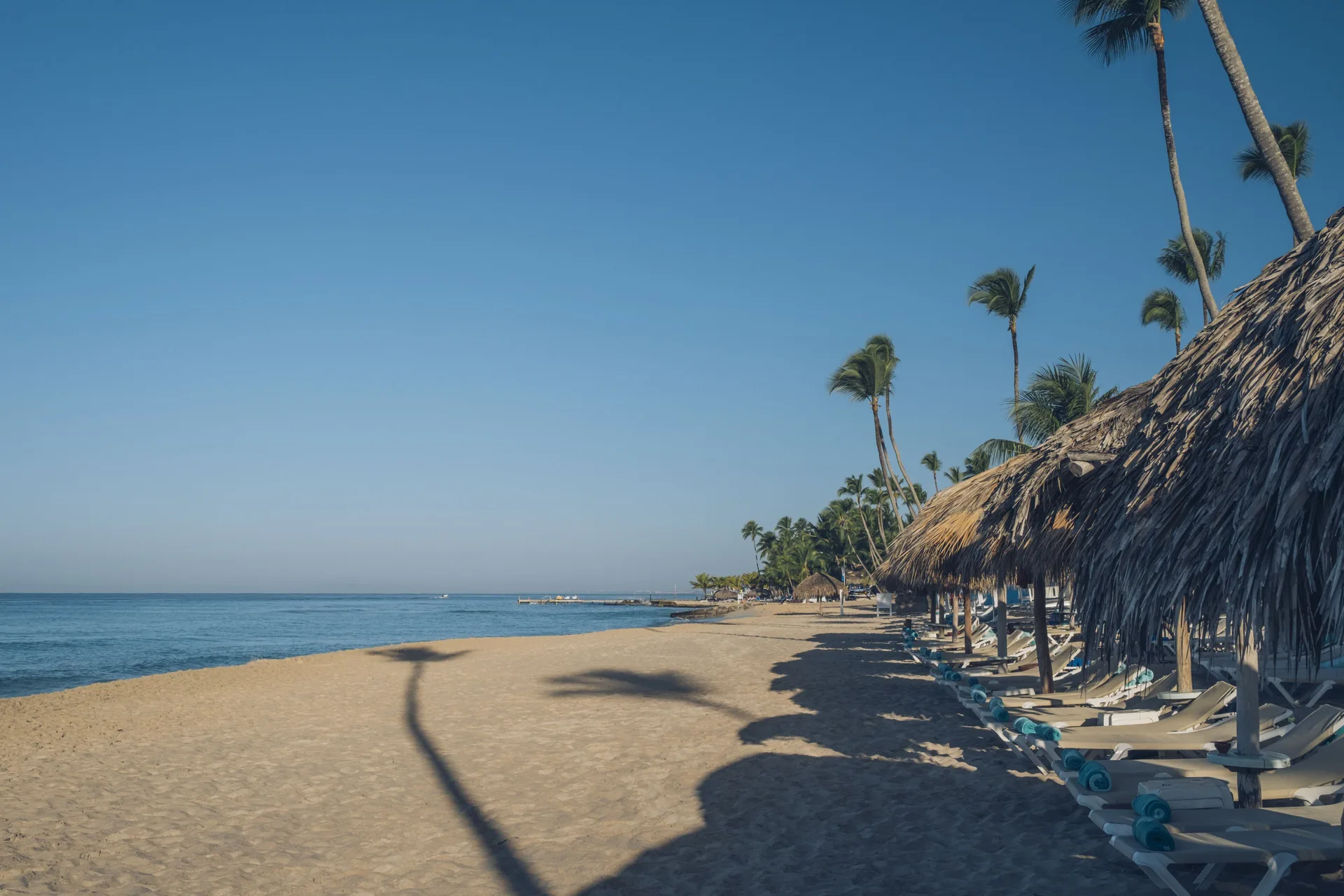 Thatched beach loungers line the sand at Iberostar Selection Hacienda Dominicus.
